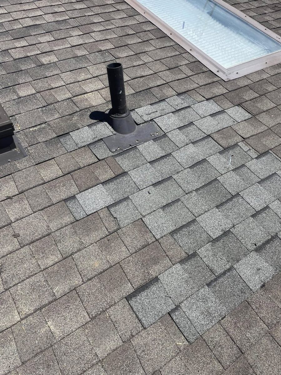 Same roof section after repair with new shingles and a sealed vent boot