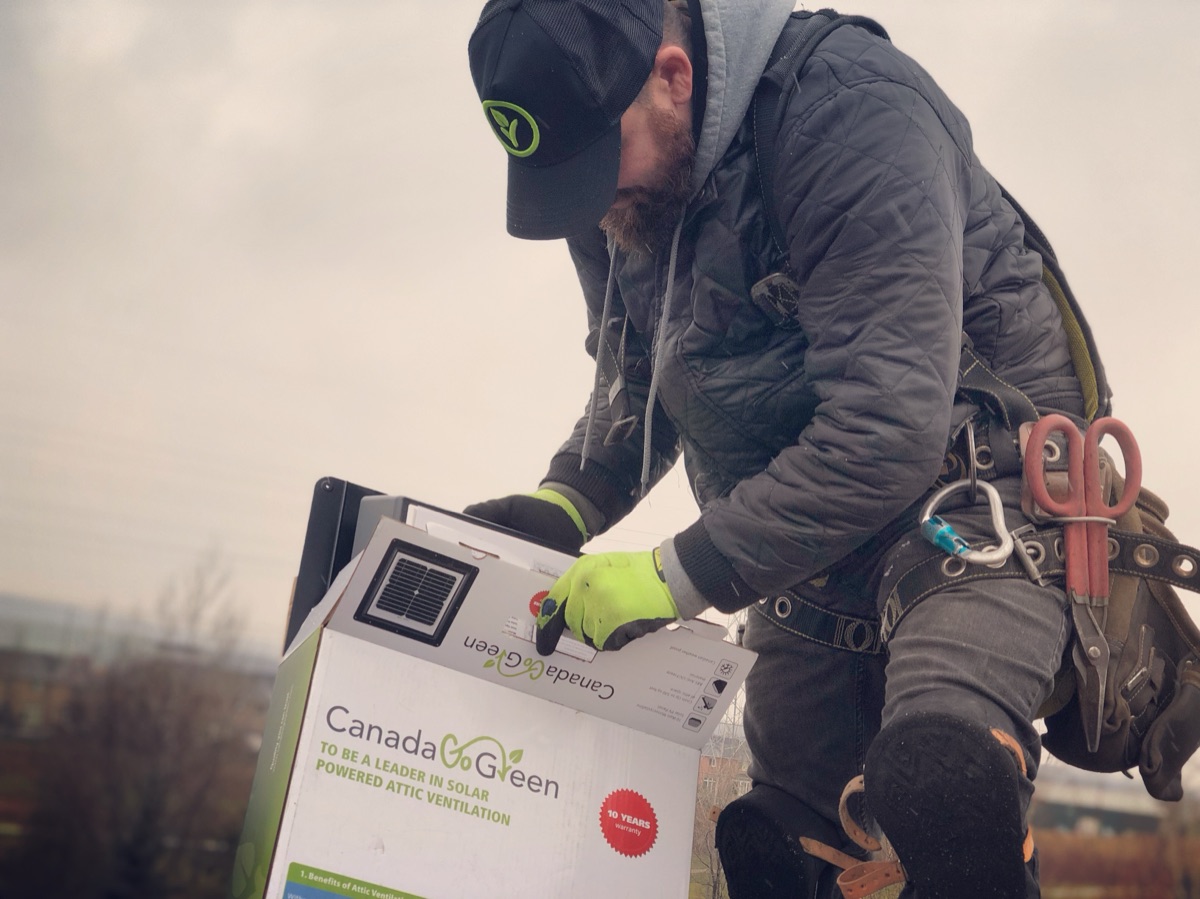 Beaudry roofer installing a solar-powered attic ventilation unit on a roof